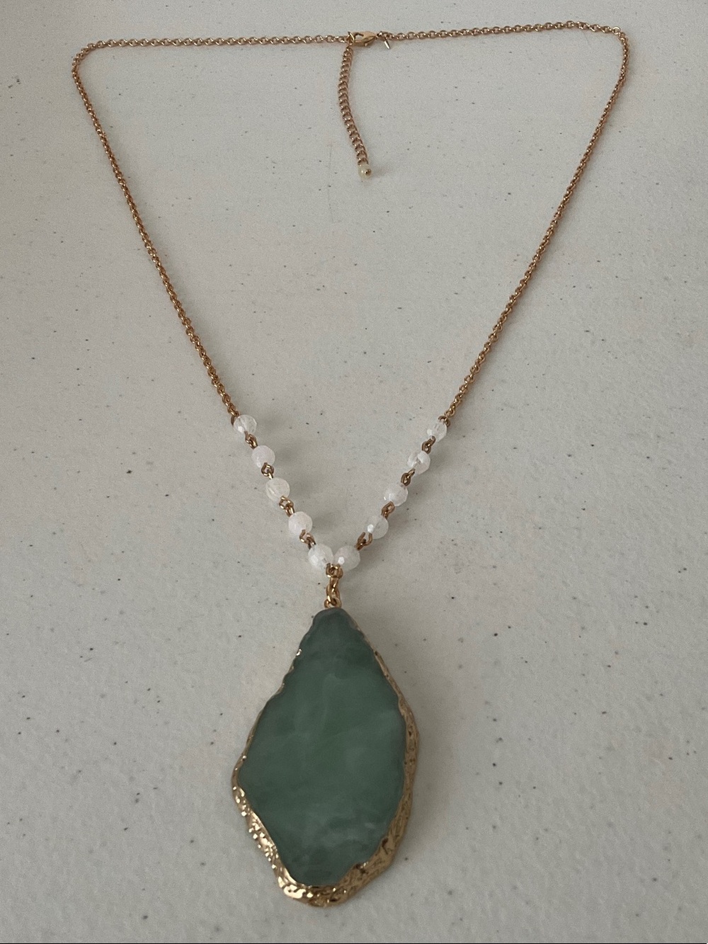 Gold-Tone Necklace with Green Stone Pendant and White Beads